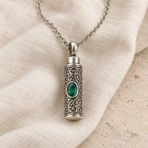 Sterling silver cremation necklace resting on natural ivory linen